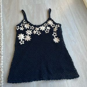 black crochet spaghetti strap top with white flower detailing.